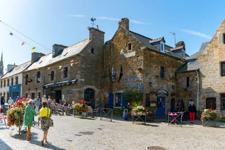 Rue d'un village breton composé d'ancienne maison en pierre jaune et grise