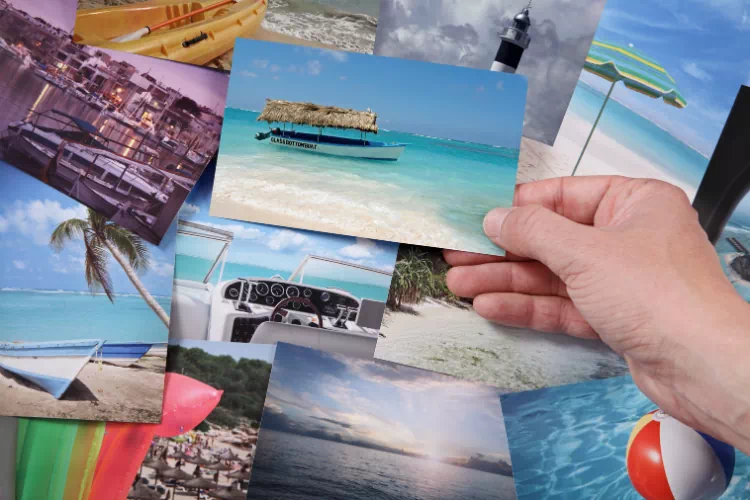 Personne tenant une photo de voyage dans sa main
